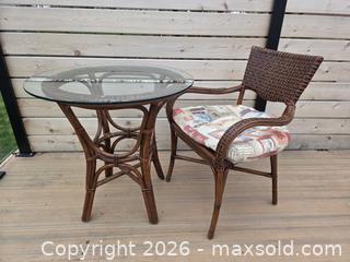MaxSold Auction: 2-Piece Vintage Multi Brown Rattan and Bamboo Bistro/Patio Set with Glass Top & Cushions - Table - 29.5"W x 30"H      Chair - 23.75"W x 33.75"H - Kingston (Ontario, Canada) SELLER MANAGED Downsizing Online Auction - Abdo Road