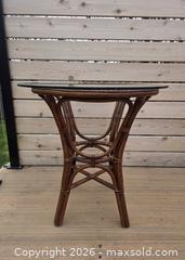 MaxSold Auction: 2-Piece Vintage Multi Brown Rattan and Bamboo Bistro/Patio Set with Glass Top & Cushions - Table - 29.5"W x 30"H      Chair - 23.75"W x 33.75"H - Kingston (Ontario, Canada) SELLER MANAGED Downsizing Online Auction - Abdo Road