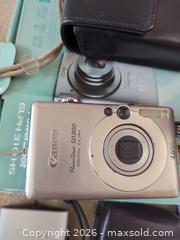 MaxSold Auction: Mixed Compact Digital Cameras with HP Sprocket Printer & Accessories - Saanich (British Columbia, Canada) PARTNER MANAGED Moving Online Auction - Cordova Bay Road (CONDO)
