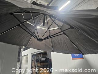 MaxSold Auction: Used Patio Offset Umbrella with weighted base assembly and cover - Mississauga (Ontario, Canada) SELLER MANAGED Reseller Online Auction - Platinum Drive (STORAGE)