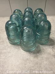 MaxSold Auction: GTP TEL CO. lot of 10 vintage utility company glass insulators.  - Red Deer (Alberta, Canada) SELLER MANAGED Downsizing Online Auction - Dempsey Street