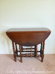 MaxSold Auction: Gibbard Solid Walnut Drop-Leaf Table, Round Top with etched detail - Tillsonburg (Ontario, Canada) SELLER MANAGED Downsizing Online Auction - Wilson Avenue