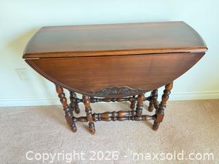 MaxSold Auction: Gibbard Solid Walnut Drop-Leaf Table, Round Top with etched detail - Tillsonburg (Ontario, Canada) SELLER MANAGED Downsizing Online Auction - Wilson Avenue