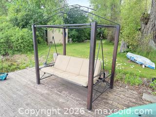 MaxSold Auction: 3-Person Metal Porch Swing with Beige Cushions - Leeds And The Thousand Islands (Ontario, Canada) SELLER MANAGED Moving Online Auction - Chisamore Point Road