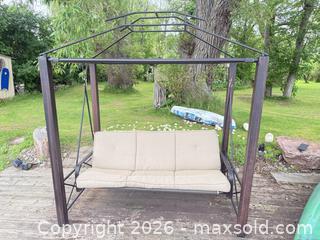 MaxSold Auction: 3-Person Metal Porch Swing with Beige Cushions - Leeds And The Thousand Islands (Ontario, Canada) SELLER MANAGED Moving Online Auction - Chisamore Point Road