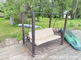 MaxSold Auction: 3-Person Metal Porch Swing with Beige Cushions - Leeds And The Thousand Islands (Ontario, Canada) SELLER MANAGED Moving Online Auction - Chisamore Point Road