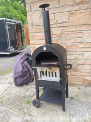 MaxSold Auction: Black Wood-Fired Portable Outdoor Pizza Oven on Cart - Leeds And The Thousand Islands (Ontario, Canada) SELLER MANAGED Moving Online Auction - Chisamore Point Road