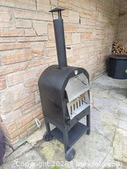 MaxSold Auction: Black Wood-Fired Portable Outdoor Pizza Oven on Cart - Leeds And The Thousand Islands (Ontario, Canada) SELLER MANAGED Moving Online Auction - Chisamore Point Road
