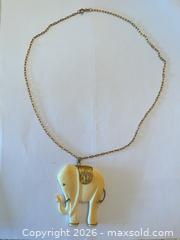 MaxSold Auction: (10K) Gold Paperclip Chain with White Carved Elephant Pendant - New Westminster (British Columbia, Canada) PARTNER MANAGED Downsizing Online Auction - Quayside Drive (CONDO)