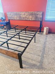 MaxSold Auction: Black and wooden King size bed frame with a new king size mattress included.  - Johnstown (Colorado, USA) SELLER MANAGED Downsizing Online Auction -  Sloan Drive