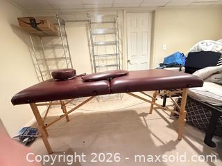 MaxSold Auction: Portable Burgundy Vinyl Massage Table with Wood Frame - Longmont (Colorado, USA) SELLER MANAGED Downsizing Online Auction - Trail Ridge Road
