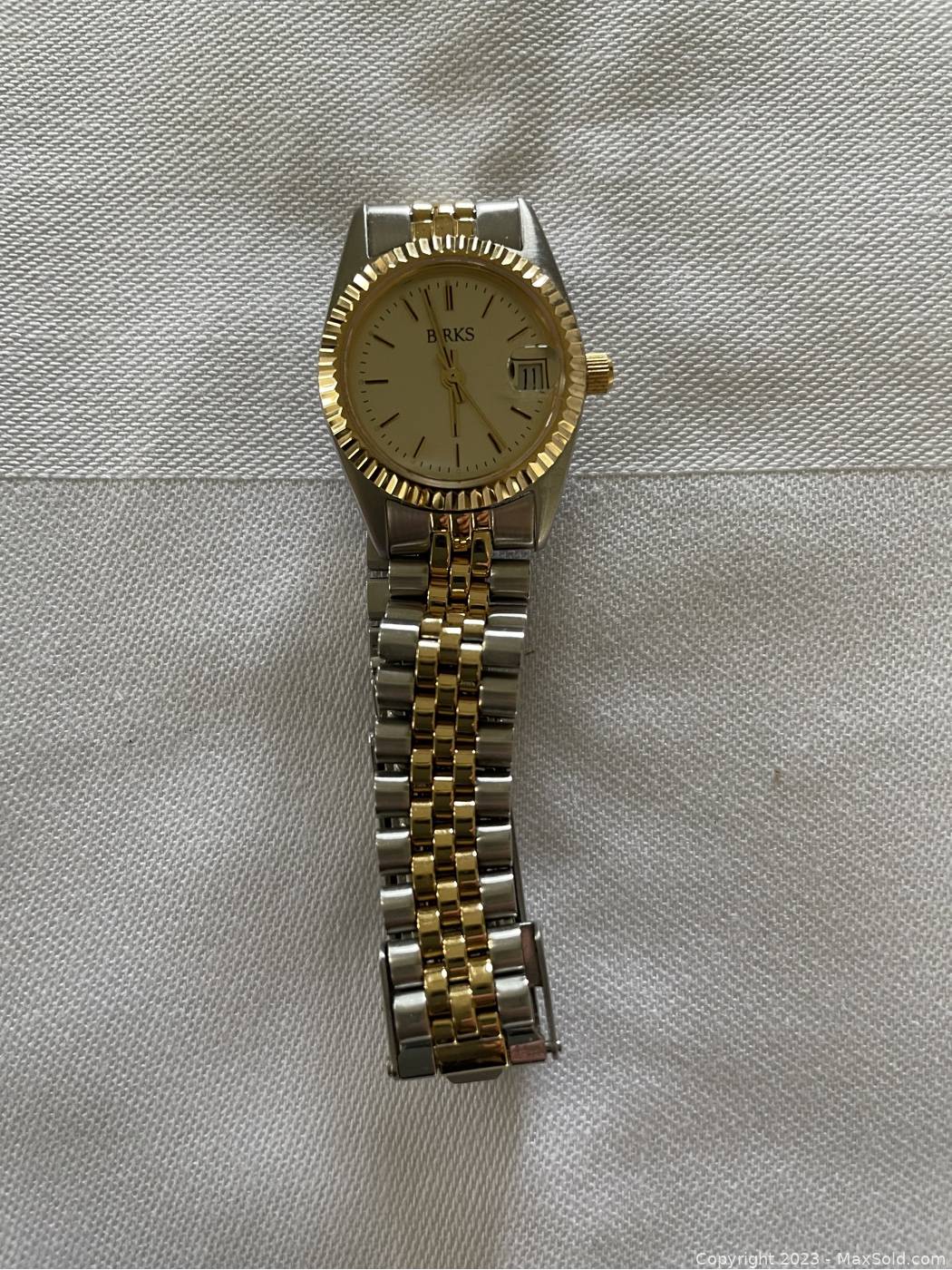 Lot 235 - Birks - A lady's yellow metal wrist watch.