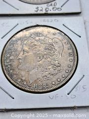 MaxSold Auction: Four USA Morgan Silver Dollars and an Eisenhower Dollar - Burnside (British Columbia, Canada) PARTNER MANAGED Estate Sale Online Auction - Hillside Avenue